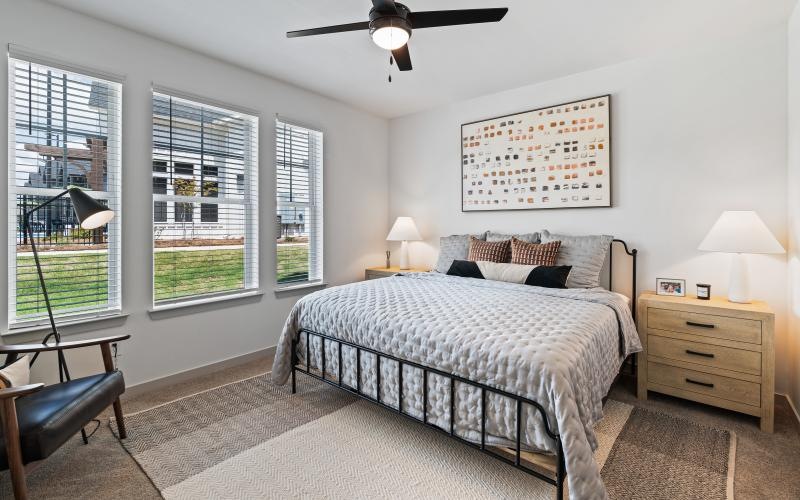 a bedroom with a bed and two nightstands