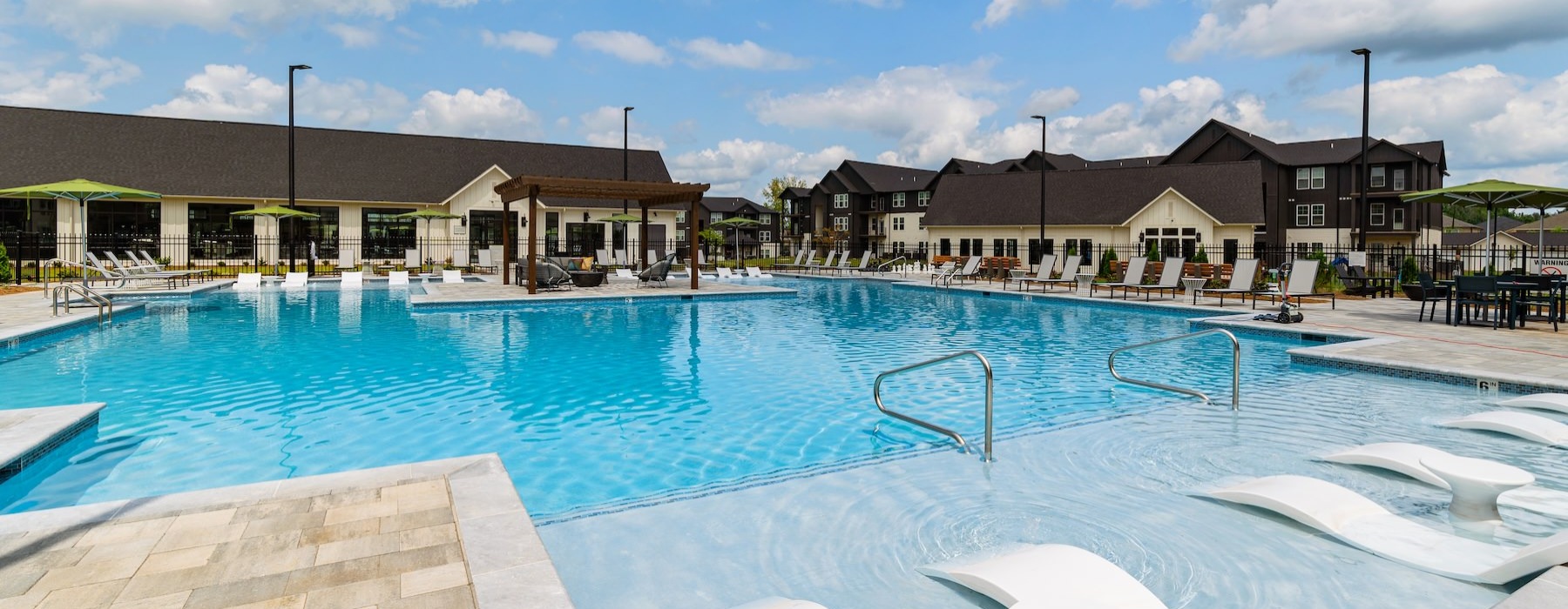 a swimming pool with lounge chairs around it