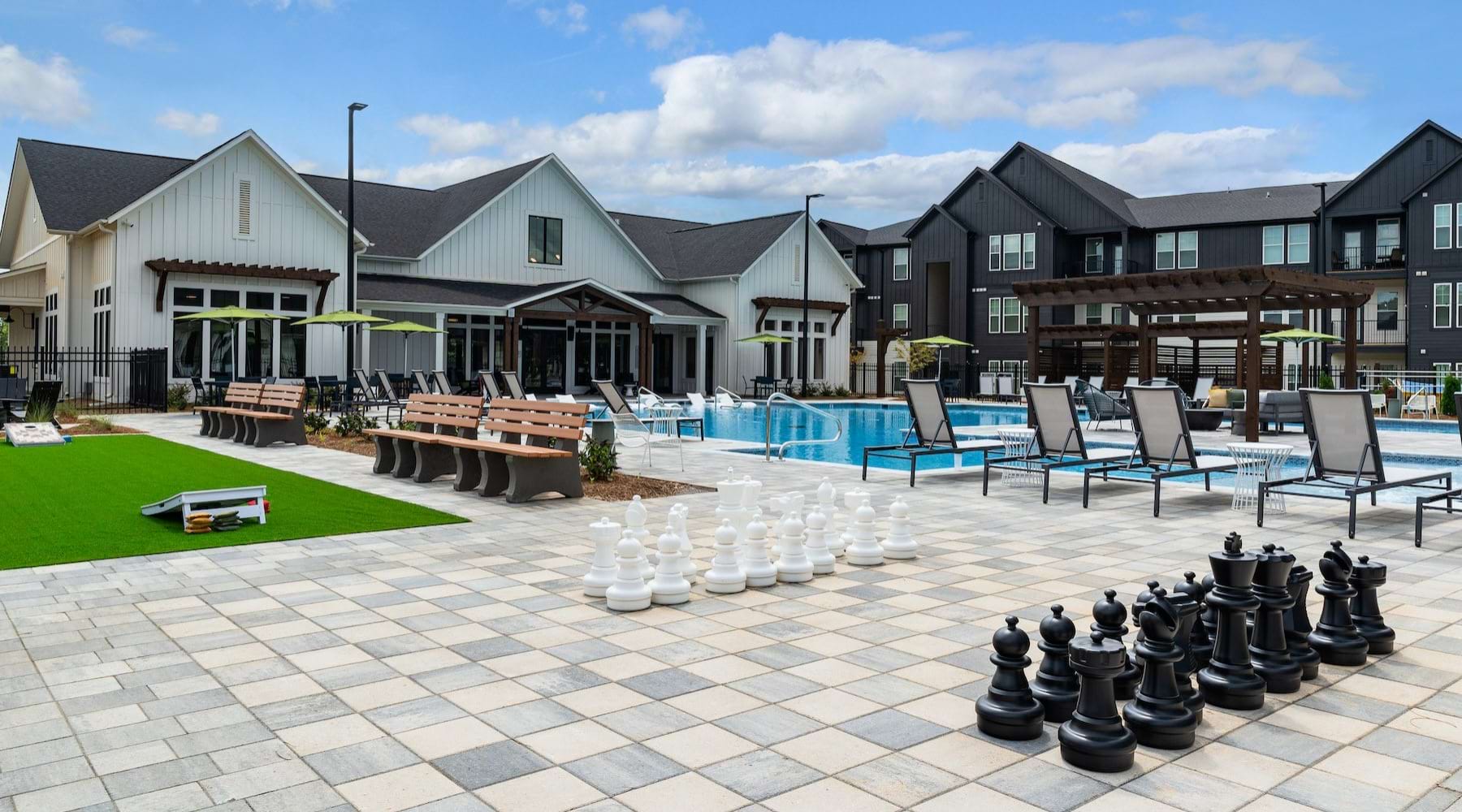 a courtyard with a large chess game and a pool