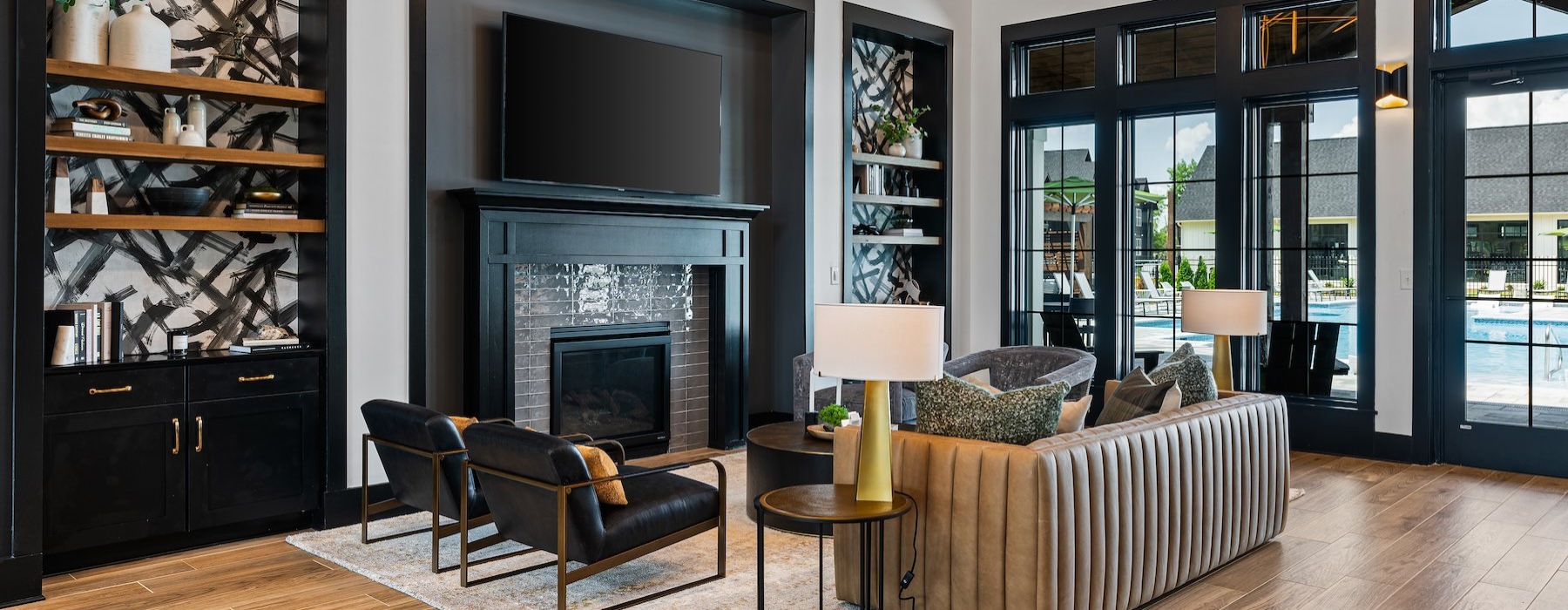 a lounge with a tv, couch and chairs