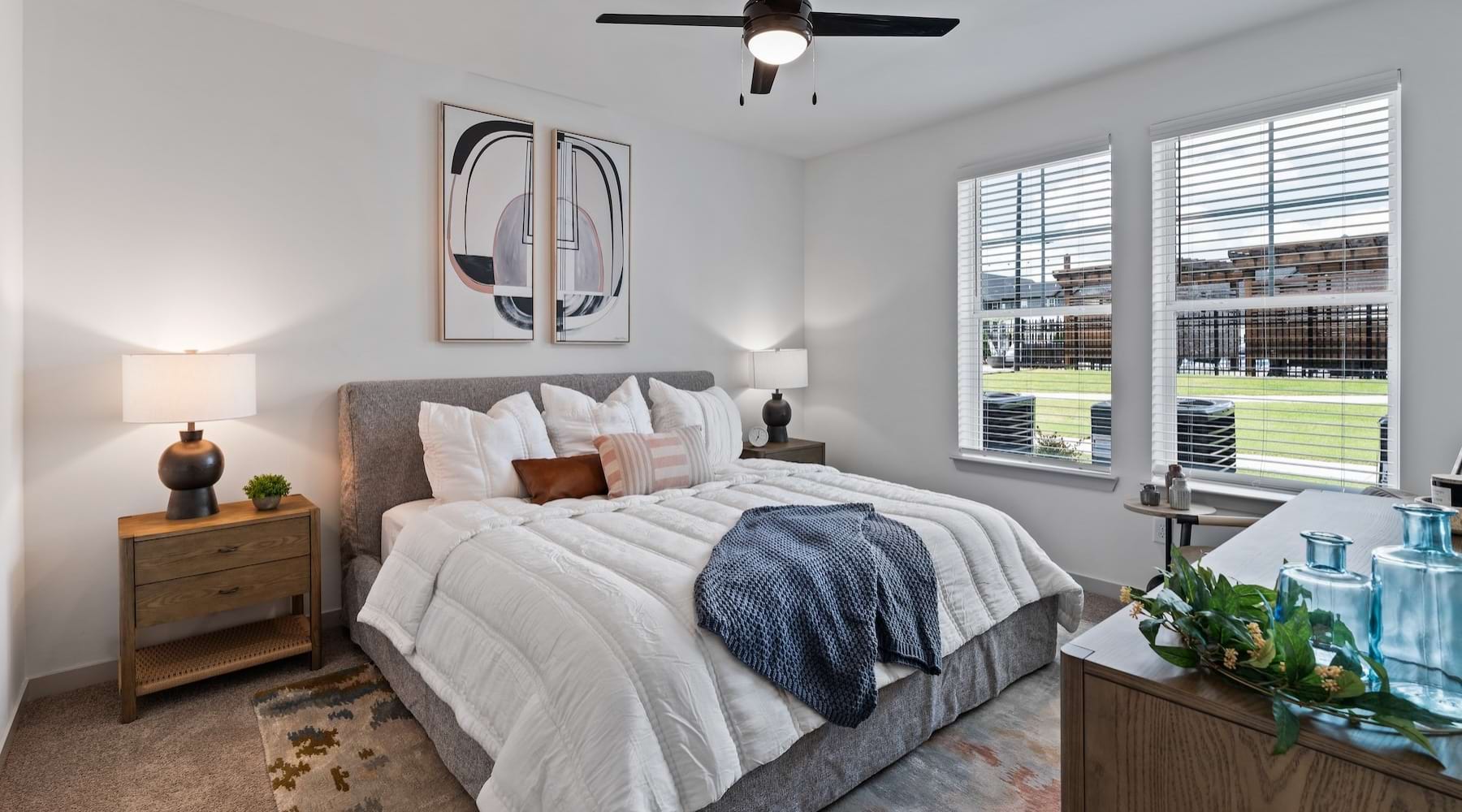 a bedroom with a bed and two nightstands